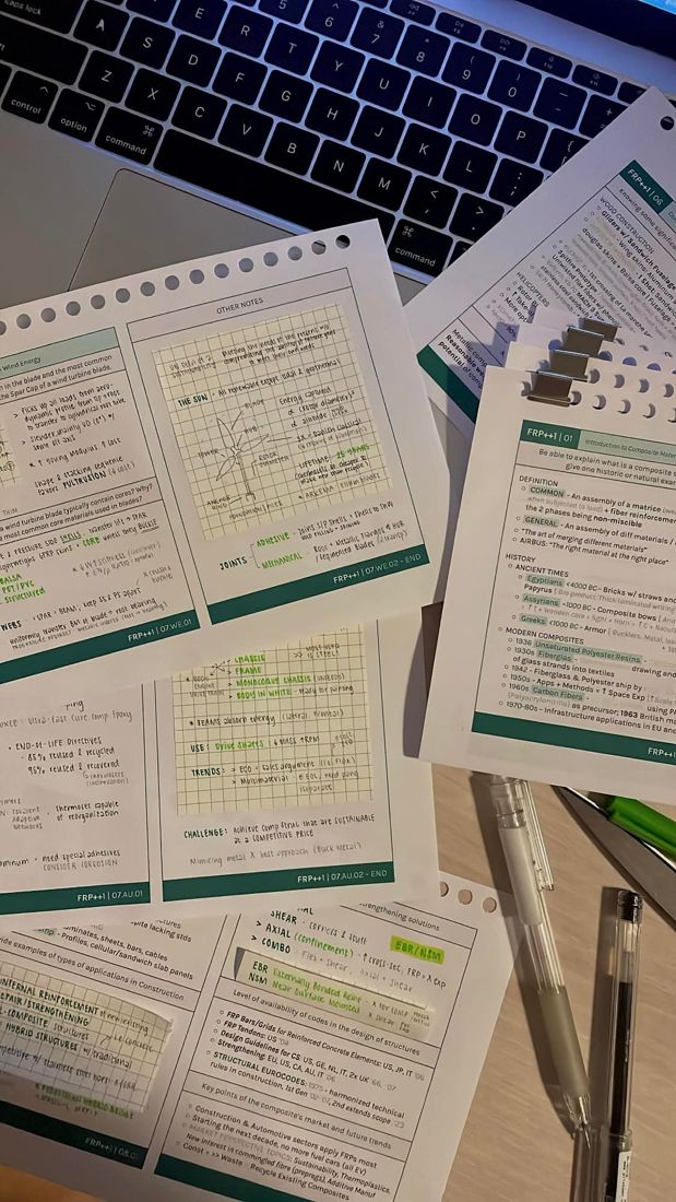 Handwritten course notes spread across a desk