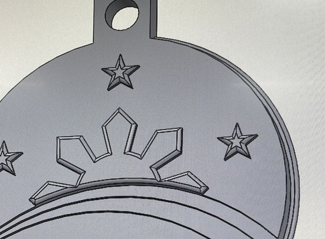 A metal plate engraved with a star and sun, made during the PhilSA internship